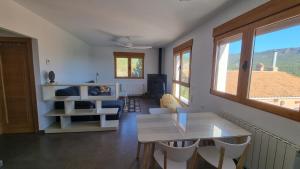 a living room with a white table and chairs at Casa de la Santa in Moratalla