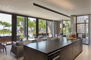 a kitchen with a large island in a living room at YAMA Resort in Kibbutz Ginnosar