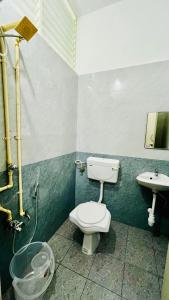 ein Bad mit einem WC und einem Waschbecken in der Unterkunft Hotel Star Nivas, Srirangam in Tiruchchirāppalli