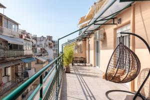 a balcony with a basket hanging from a building at Penthouse No7 - #TIF Helexpo in Thessaloniki