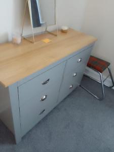 a white desk with a wooden top and a chair at Mide’s House in Invergowrie