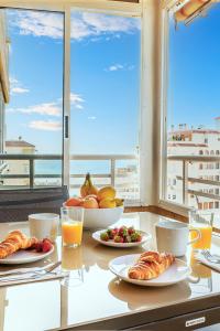 a table with plates of food on a table with a view at Myflats Premium Arenales Hills in Arenales del Sol