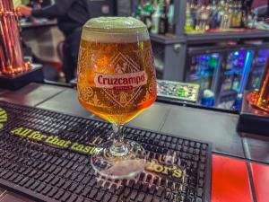 a glass of beer sitting on top of a bar at Ye Olde Original Withy Trees in Bamber Bridge