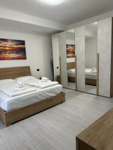 a bedroom with two beds and a large mirror at Cavour Apartment Center Bardolino in Bardolino