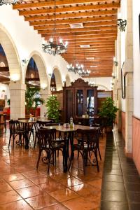 a dining room with tables and chairs in a building at ALEGRIA Bodega Real in El Puerto de Santa María