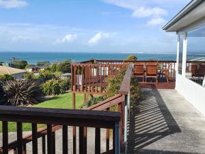 a balcony of a house with a view of the ocean at Panoramic Views on Walter in Bridport