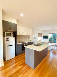 a kitchen with a white refrigerator and a counter top at 2B house with private entry free parking 4mins to Airport in Melbourne