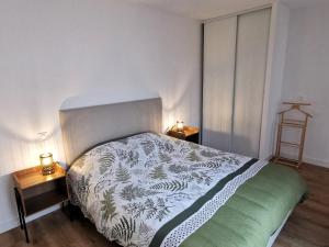 a bedroom with a bed and two night stands at La Petite Marine a 150m de la plage in Brétignolles-sur-Mer