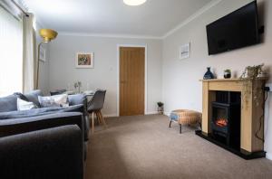 a living room with a couch and a fireplace at Number 4 in Fort William