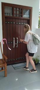 a young girl standing in front of a door at Villa 142 in Weligama