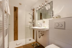 a bathroom with a sink and a shower at Hotel Sauerländer Hof in Willingen