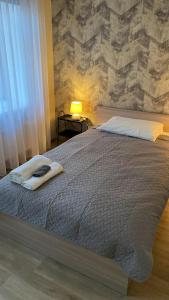 a bedroom with a large bed with a stone wall at Neiroprakse Mini Hotel in Daugavpils