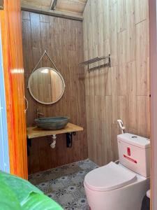 a bathroom with a sink and a toilet and a mirror at Cloud9 Glamping & Cafe in Xuân Trường