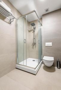 a shower stall in a bathroom with a toilet at Regency Hotel in Chişinău