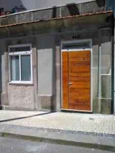 een houten deur aan de zijkant van een gebouw bij Casa Camões II in Porto