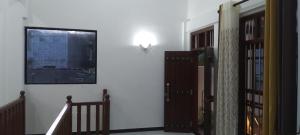 a hallway with a staircase and a wall with two doors at Villa 142 in Weligama +22 photos