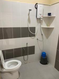 a bathroom with a shower and a toilet at Maze Roomstay Langkawi in Pantai Cenang