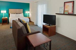 a hotel room with a bed and a couch and a television at Residence Inn Cherry Hill Philadelphia in Cherry Hill