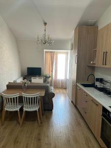 a kitchen and living room with a table and chairs at Apartment in Agmashenebeli in Tbilisi City