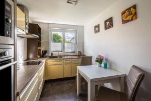 a kitchen with yellow cabinets and a table and a window at Gasthaus in Essen in Essen