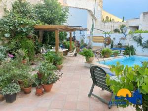a patio with potted plants and a swimming pool at La Toscana de Letur in Letur