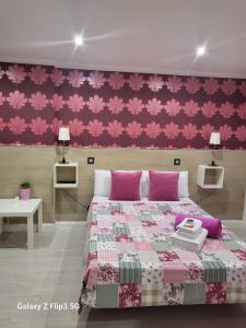 sypialnia z łóżkiem z różowymi kwiatami na ścianie w obiekcie Hostal Inn Madrid w Madrycie
