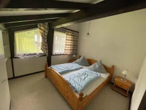 a bedroom with a wooden bed with blue sheets at Ferienwohnung Zirbelweg in Siegsdorf