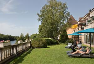 two people sitting on lounge chairs in the grass at La C&ocirc;te Saint Jacques in Joigny