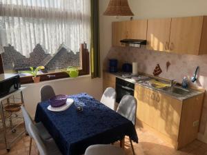 a kitchen with a table with a blue table cloth on it at Haus Gertrud in Bad Sachsa