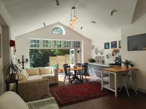 a living room with a couch and a table at Peaceful Getaway in Forested Park in Bournemouth