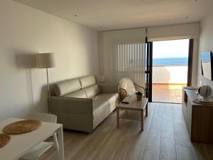 a living room with a couch and a table at Apartamento en Los Cristianos in Los Cristianos