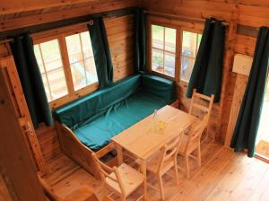 a dining room with a table and chairs in a cabin at Chalet Pyrénéen in Saint-Ybars