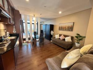 a living room with a couch and a table at Appleone Ayala Condo with Balcony in Cebu City