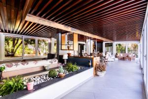 an open lobby with windows and plants at Mondello luxury villa con piscina in Mondello