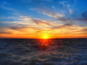 a sunset over the ocean with the sun in the sky at St Brévin - Studio - 4 Pers - Vue Mer in LʼErmitage +9 photos