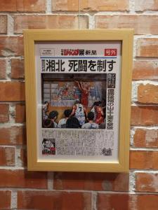 a framed picture of a baseball game on a brick wall at Tin Gan Beauty Hotspring in Yuanshan