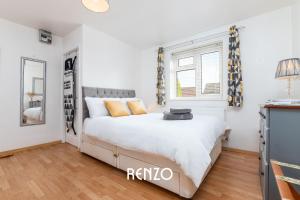 a white bedroom with a bed and a window at Beautiful 1-bed Annexe in West Bridgford, Nottingham by Renzo, Free Driveway Parking! in Nottingham