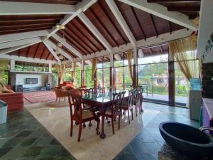 a dining room with a table and chairs at Villa Bukit Danau Lot 14 in Cinengangirang