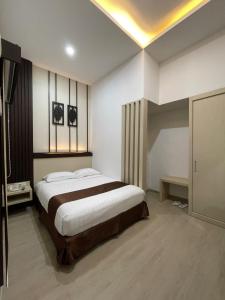 Tempat tidur dalam kamar di Dawala Hotel