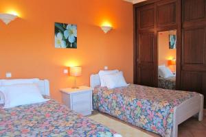 a bedroom with two beds and a mirror at 7 Bedroom Private Villa Tenazinha II, with pool in Albufeira +13 photos