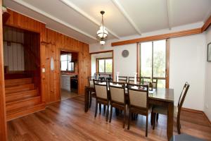 a dining room with a table and chairs at Tequila Sunset Beachfront Family Holiday Home, Bass Coast in Grantville