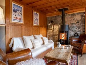 a living room with a couch and a fireplace at Chalet La Pive by Interhome in Verbier