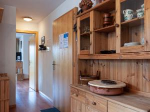a kitchen with wooden cabinets and a bowl on the counter at Apartment Les Chouettes 4 by Interhome in Nendaz