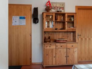 a wooden cabinet in a room next to a door at Apartment Les Chouettes 4 by Interhome in Nendaz +37 photos