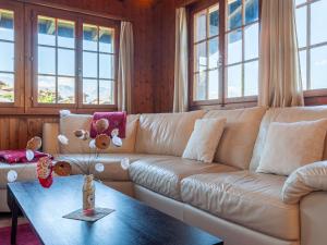a living room with a couch and a table at Chalet Mustela by Interhome in Nendaz