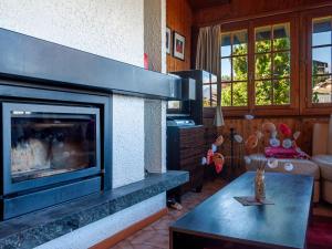 a living room with a fireplace and a couch at Chalet Mustela by Interhome in Nendaz