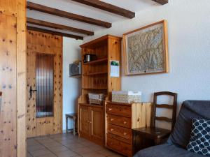 a living room with a couch and a wooden cabinet at Apartment Christiania 1 P3 by Interhome in Nendaz