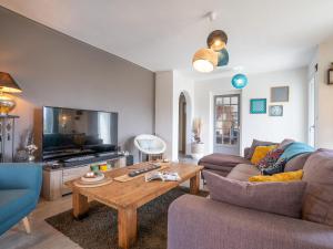 a living room with a couch and a table at Holiday Home Ty Manolo - TGX100 by Interhome in Tregueux