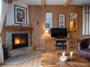 a living room with a fireplace and a television at Apartment Baudrier A04 by Interhome in Verbier