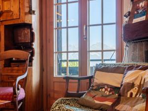 a room with a window and a chair with a blanket at Chalet Valet de Coeur by Interhome in Nendaz +38 photos